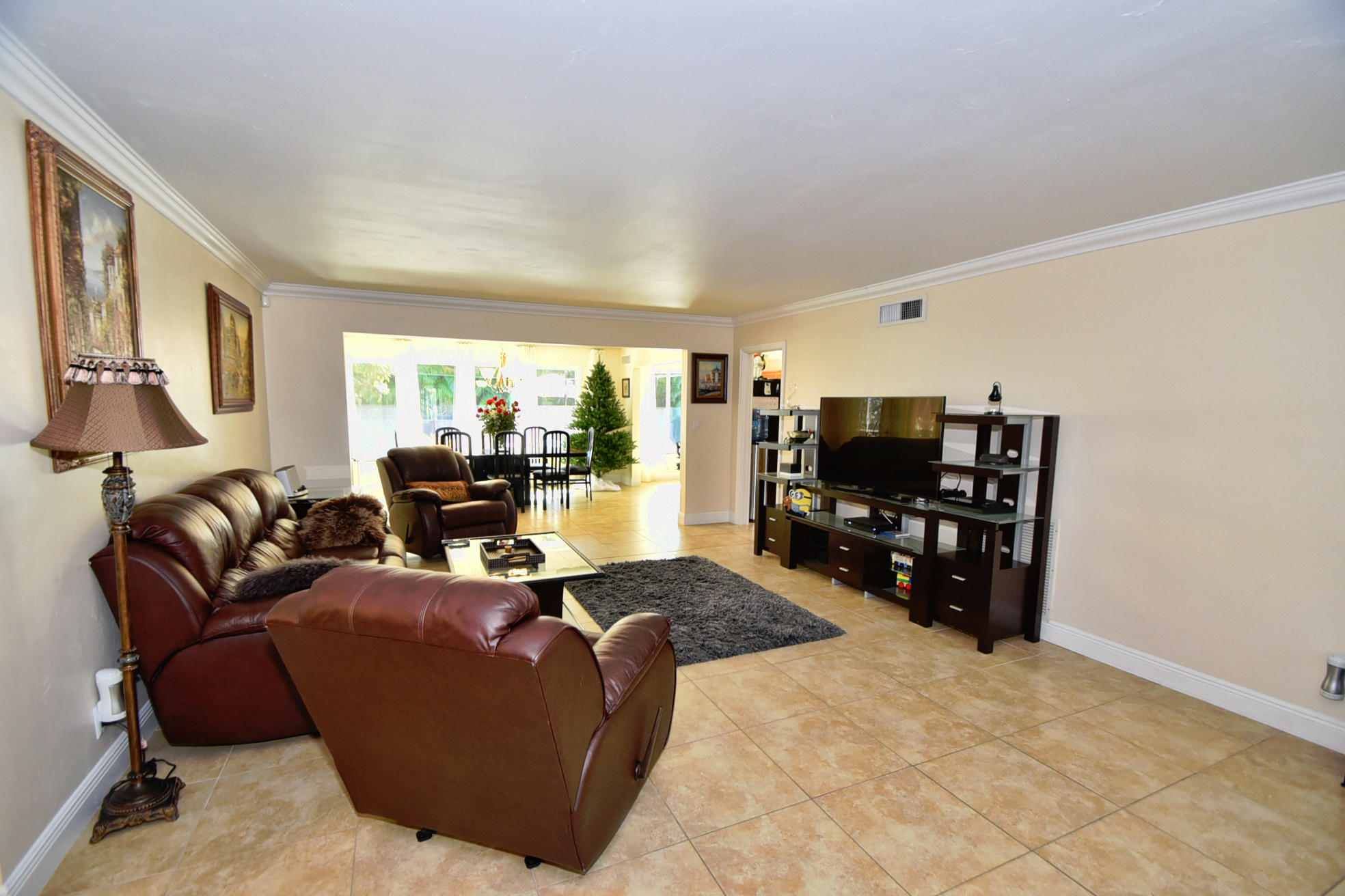 400 Northeast 2nd Street Boca Raton, FL 33432 - Photo 8 of 40 a living room with furniture a large window and bookshelf