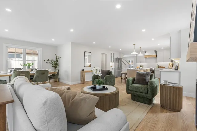 a living room with furniture kitchen and a table