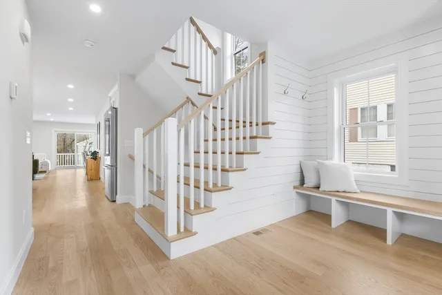 a view of entryway and hall with wooden floor
