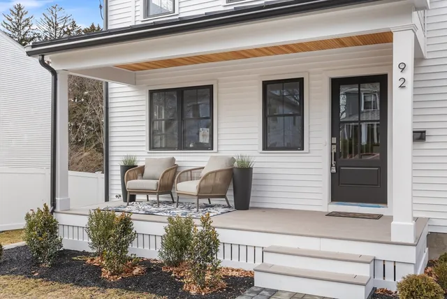a front view of a house with outdoor seating