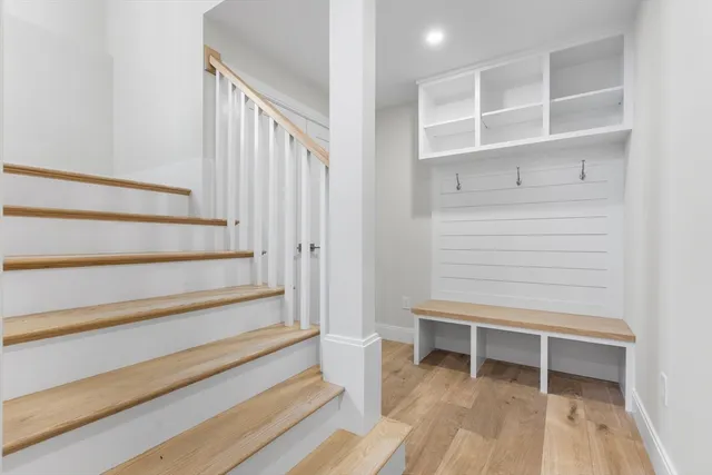 a view of an empty room with stairs and a window