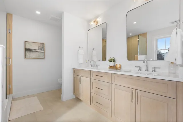 a bathroom with double sink and a mirror