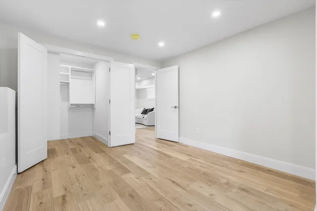 a view of empty room with wooden floor
