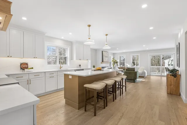 a kitchen with lots of counter top space and painting on the wall