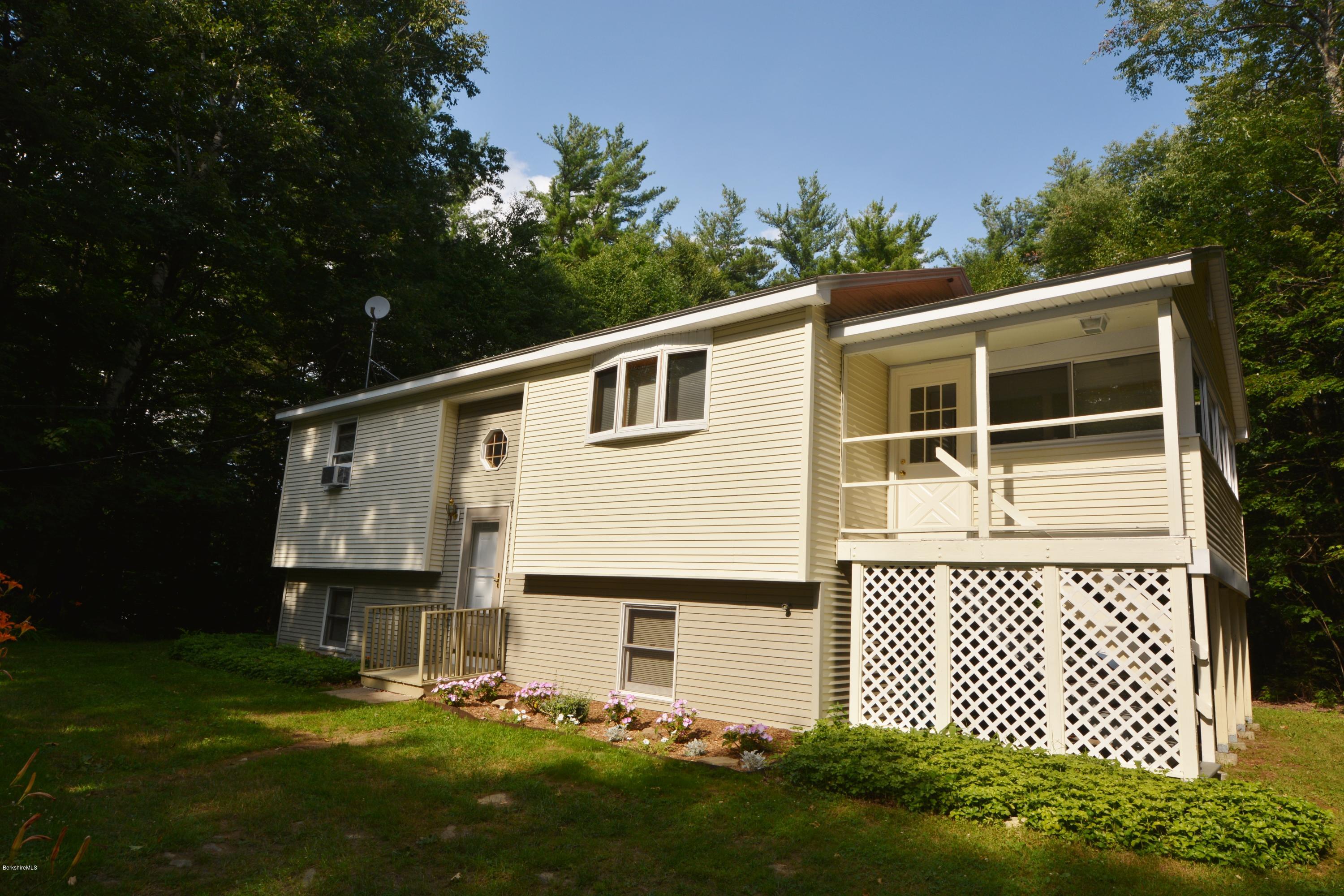 189 Tolland Road Otis, MA 01029 - Photo 1 of 16 a front view of a house with garden
