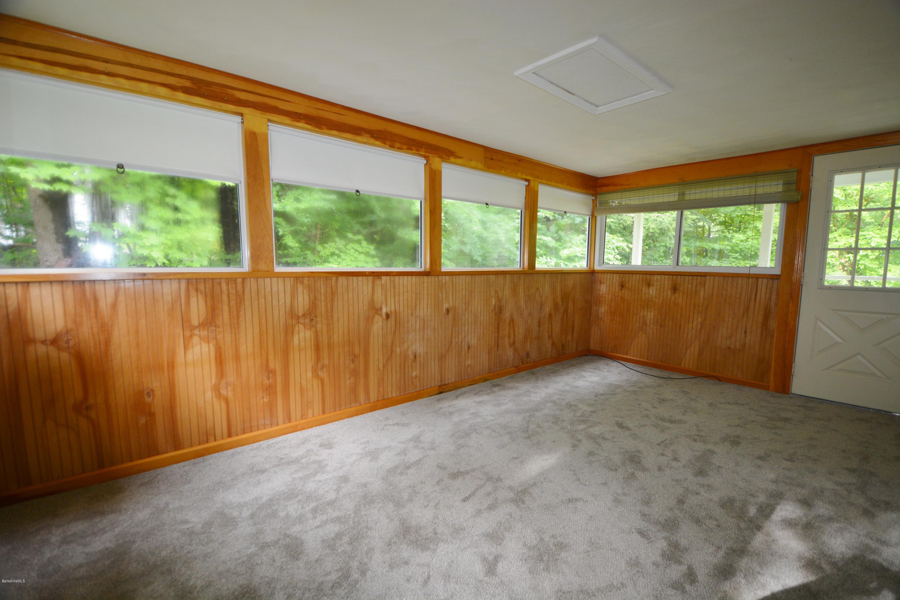 189 Tolland Road Otis, MA 01029 - Photo 8 of 16 an empty room with large windows