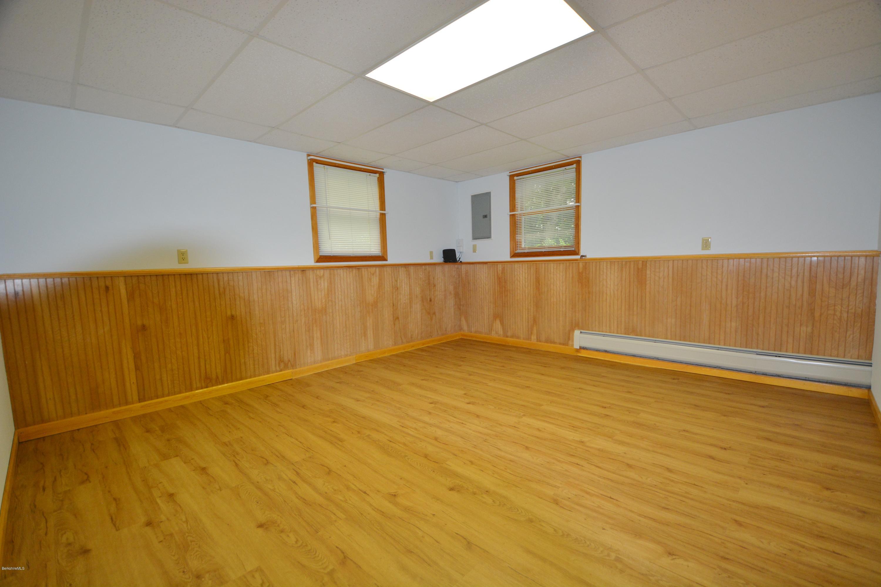 189 Tolland Road Otis, MA 01029 - Photo 10 of 16 a view of an empty room with wooden floor and a window