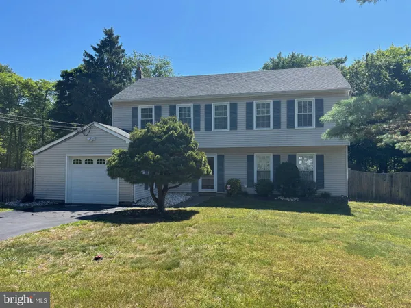 a front view of house with yard and trees