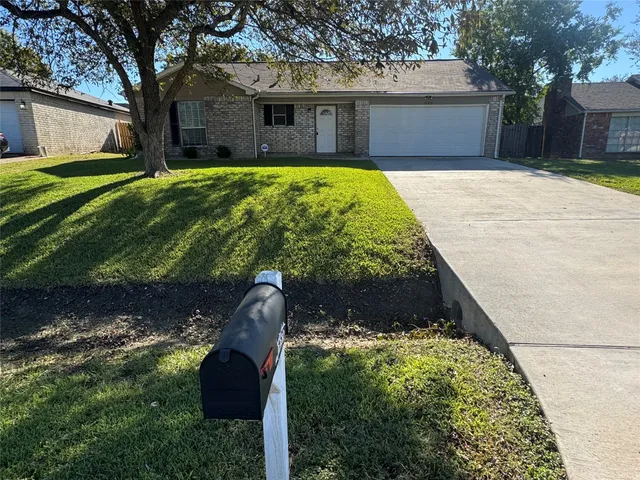a front view of house with a garden