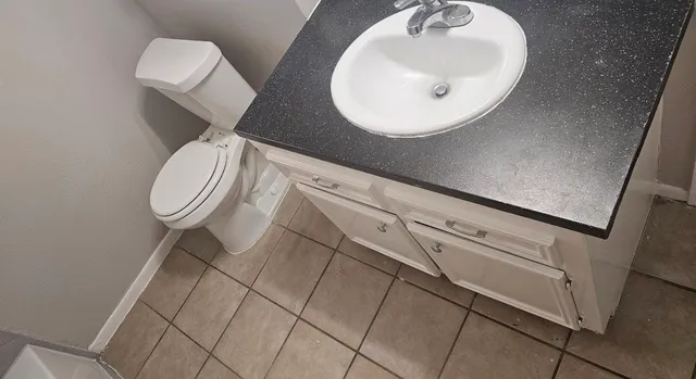 a bathroom with a sink mirror and toilet