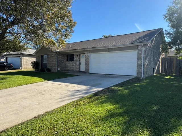a backyard of a house with large trees and a yard