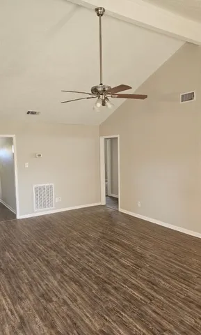 a view of a livingroom with a ceiling fan and hardwood floor