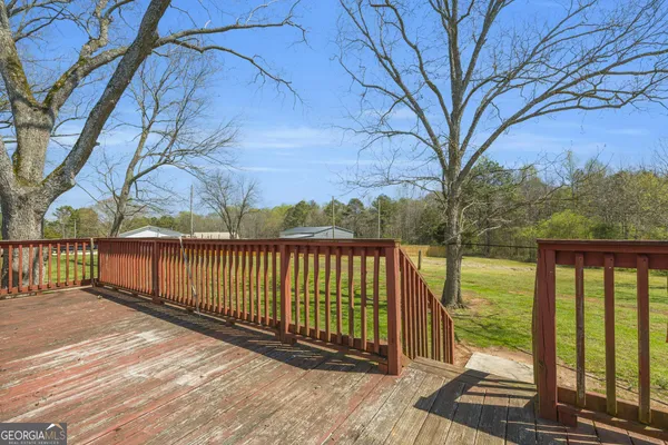 a view of balcony with wooden floor and fence