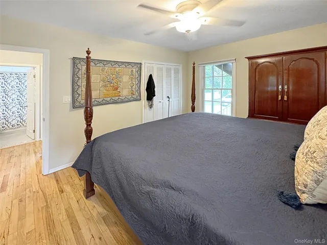 a bed sitting in a spacious bedroom next to a window