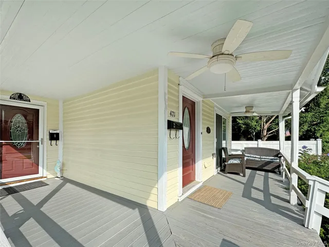 a view of a patio with table and chairs with wooden floor and fence