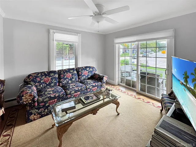 a living room with furniture gym equipment and a large window