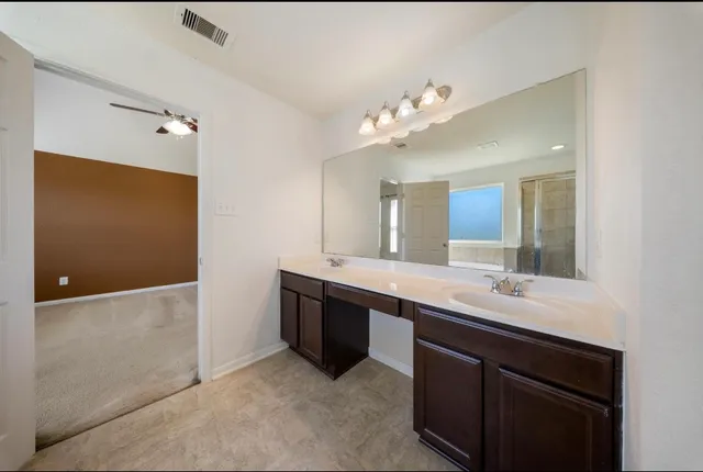 a large bathroom with a double vanity sink and mirror