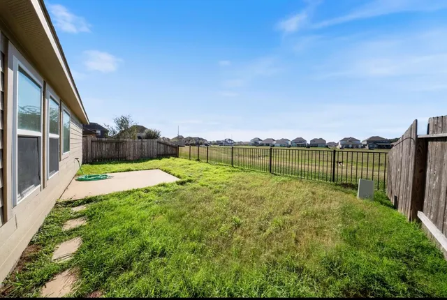 a view of a garden with wooden fence