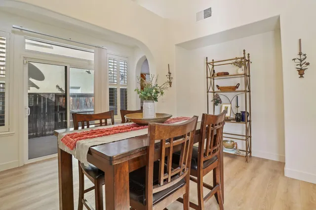 a dining room with furniture and wooden floor