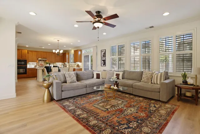 a living room with furniture and kitchen view