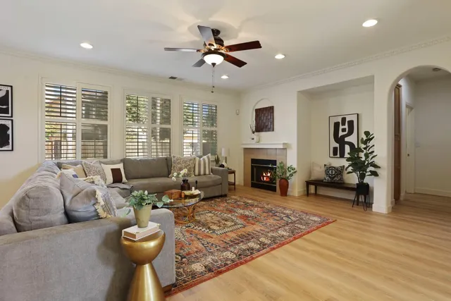 a living room with fireplace furniture and a wooden floor