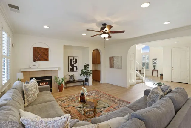 a view of a dining room with furniture a chandelier and wooden floor
