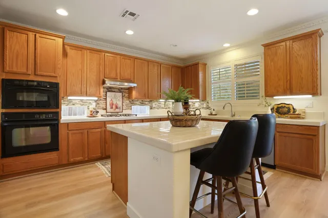 a dining room filled chandelier and wooden floor