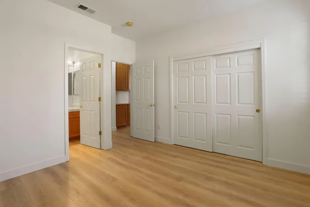 a view of staircase with lots of frames on wall and a window