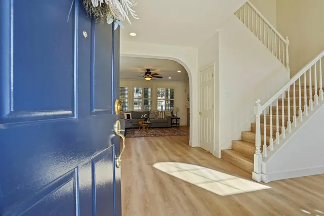 a view of a hallway with wooden floor and staircase