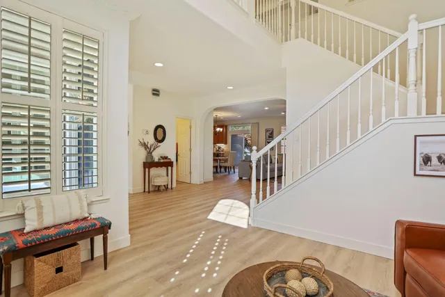 a view of entryway and hall with wooden floor