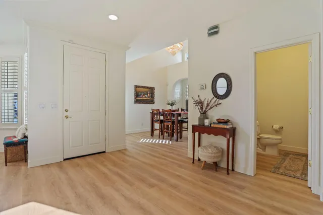 a living room with a table and a chair