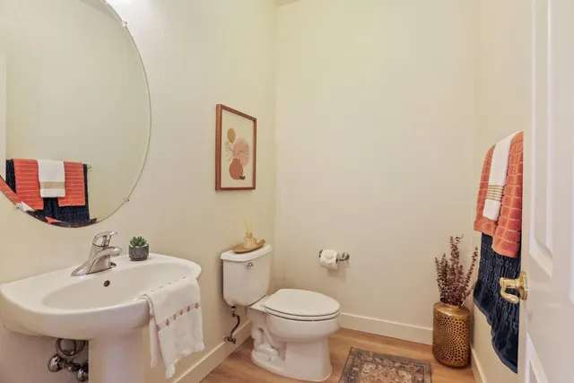 a bathroom with a sink mirror and toilet