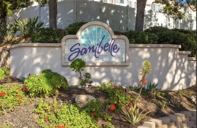 a front view of a multi story building with a yard