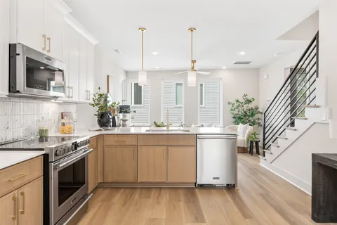 a kitchen with a sink stove and microwave