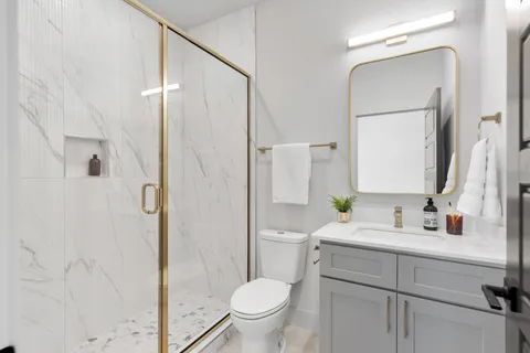 a bathroom with a sink toilet and shower