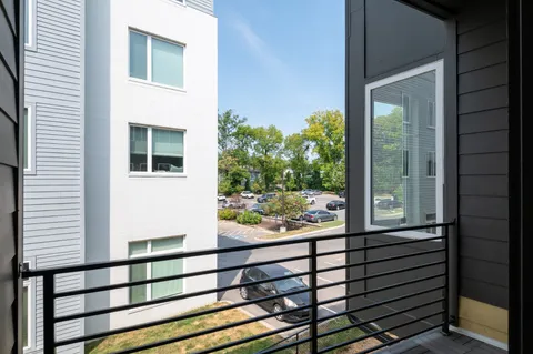 a view of a balcony with wooden floor and fence