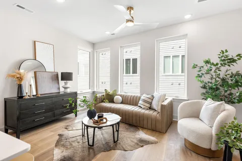 a living room with furniture a lamp and a window