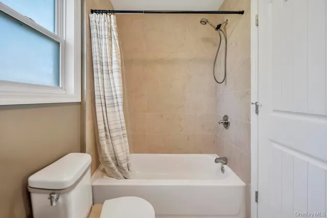 a bathroom with a shower a toilet and a shower