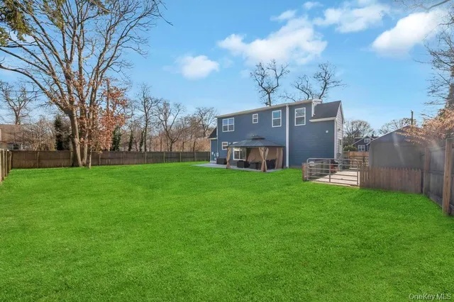 a view of a house with a big yard with large trees