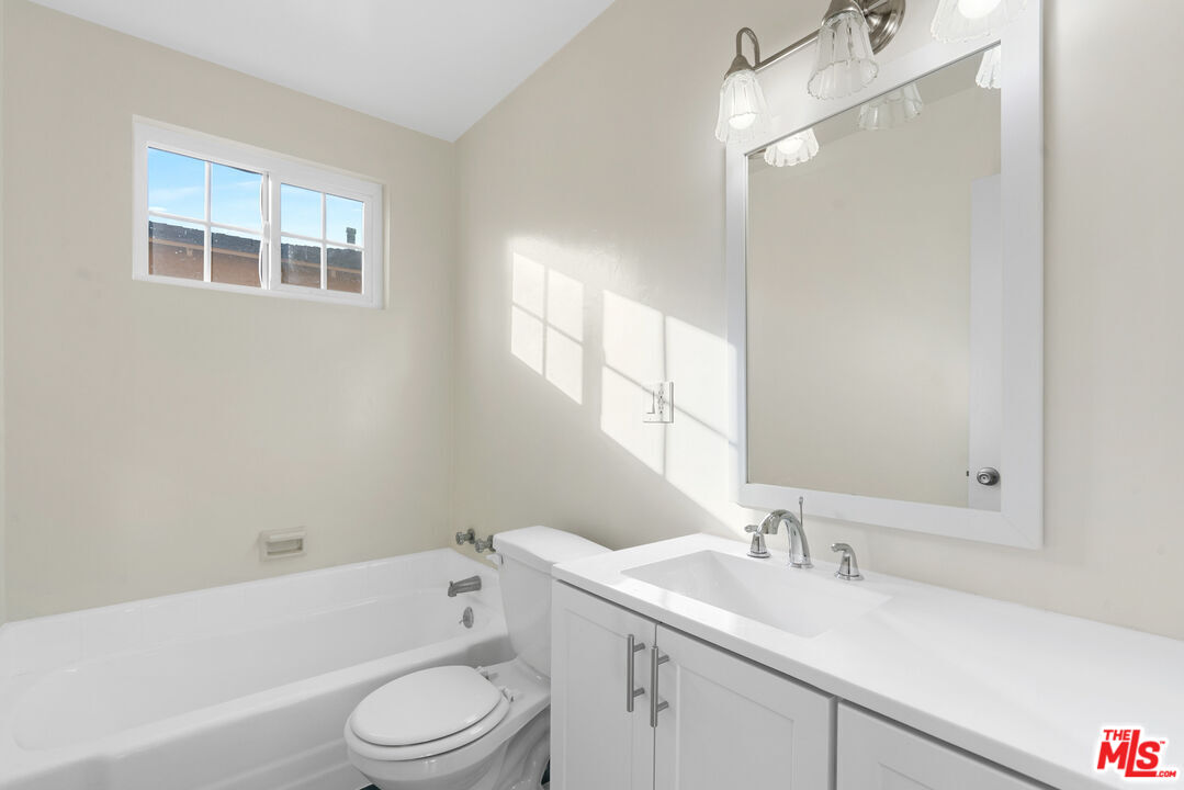 12325 Oxnard Street, Unit 6 North Hollywood, CA 91606 - Photo 11 of 11 a bathroom with a sink toilet vanity tub and shower