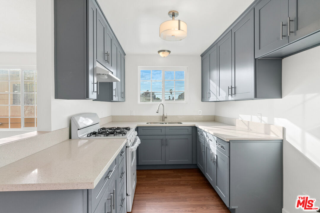12325 Oxnard Street, Unit 6 North Hollywood, CA 91606 - Photo 4 of 11 a kitchen with stainless steel appliances granite countertop a sink stove and cabinets