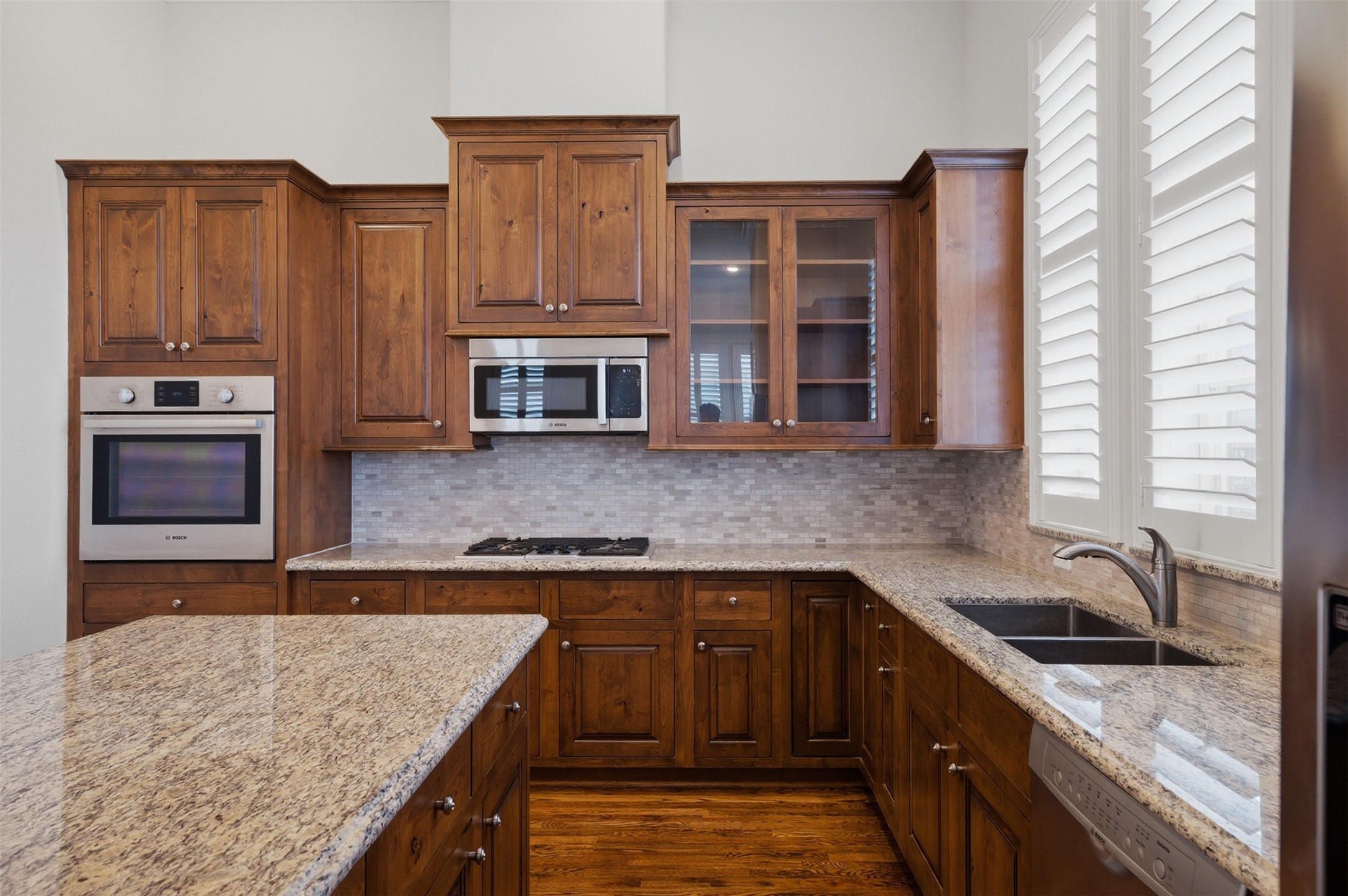 5606 Cohn Terrace Houston, TX 77007 - Photo 18 of 39 a kitchen with stainless steel appliances granite countertop a sink stove and cabinets