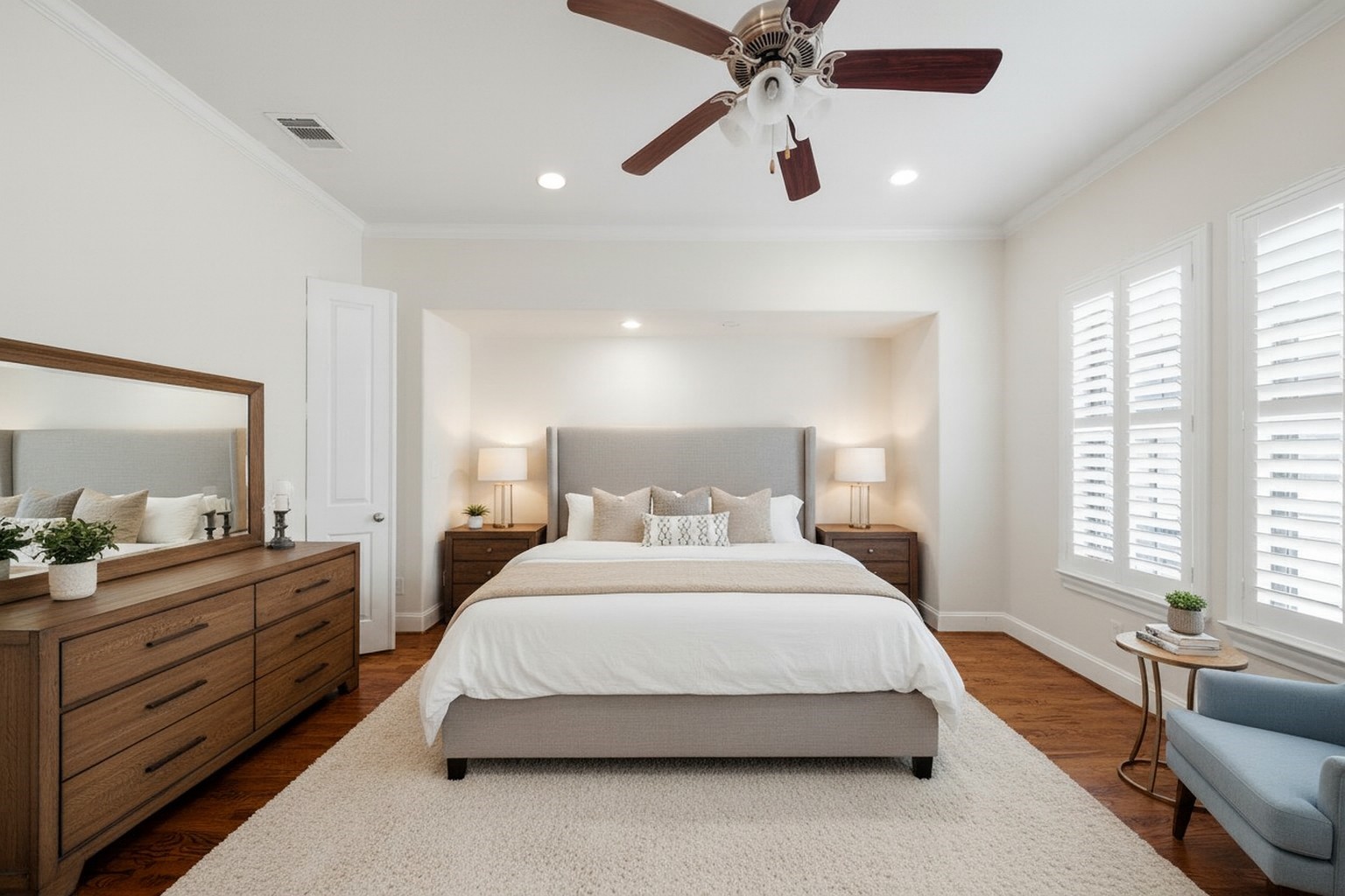 5606 Cohn Terrace Houston, TX 77007 - Photo 20 of 39 a spacious bedroom with a large bed and a chandelier