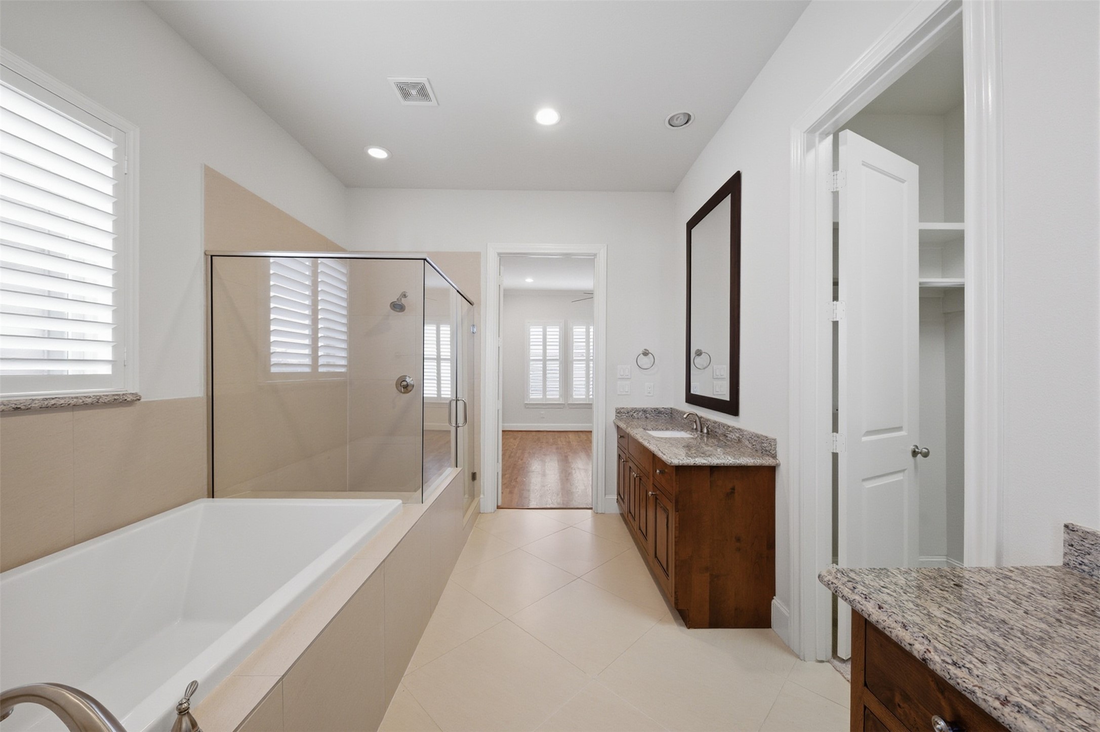 5606 Cohn Terrace Houston, TX 77007 - Photo 23 of 39 a spacious bathroom with a granite countertop tub sink and mirror