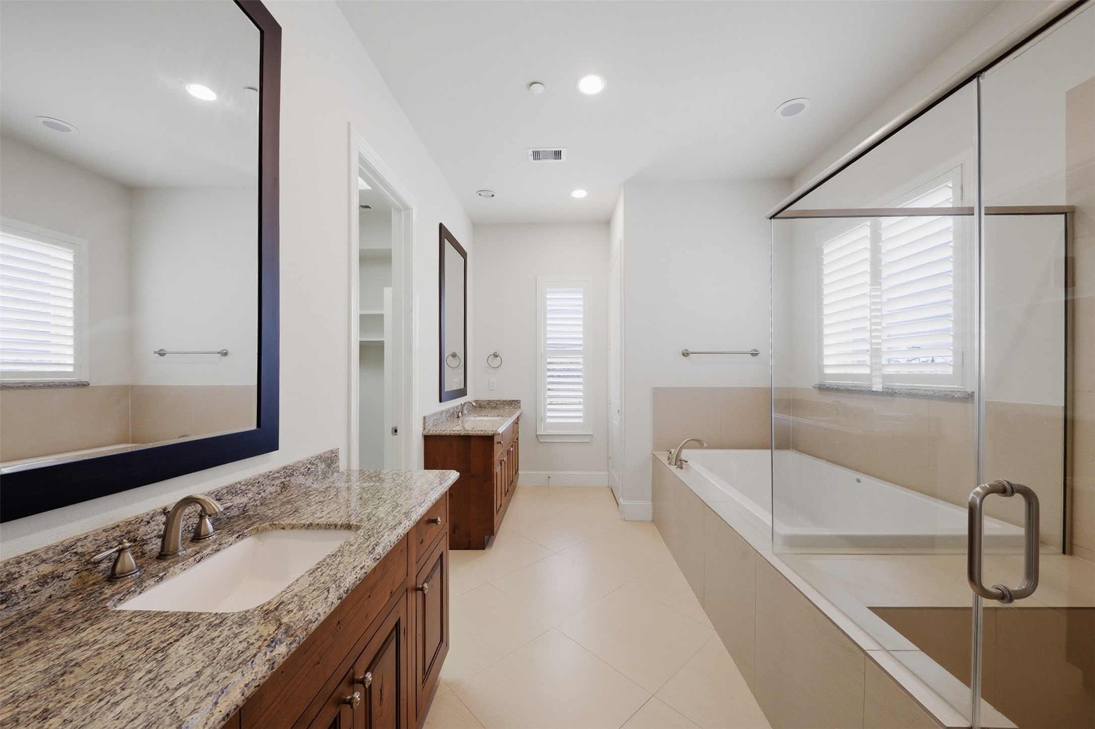 5606 Cohn Terrace Houston, TX 77007 - Photo 24 of 39 a bathroom with a granite countertop tub sink and mirror