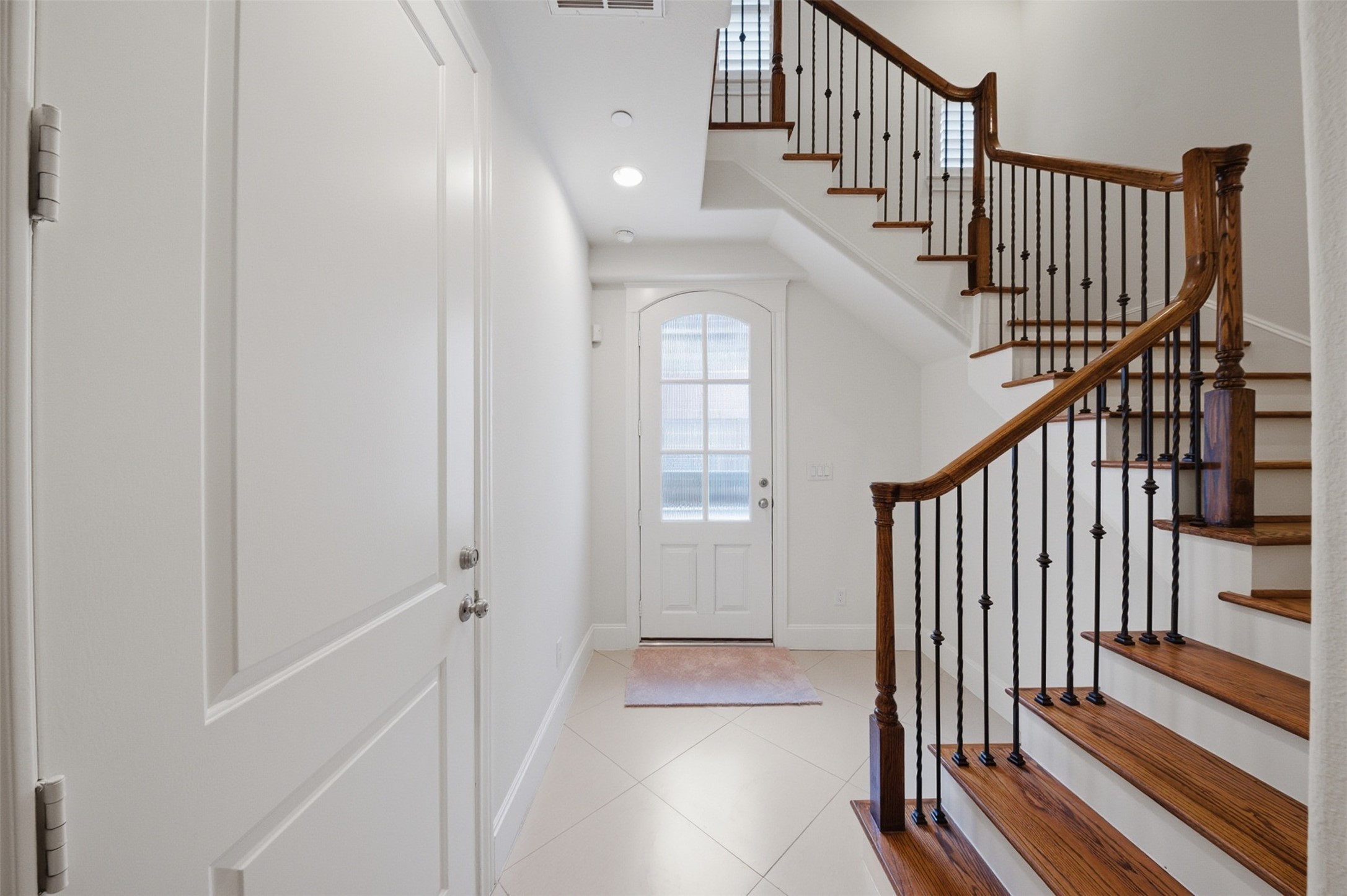 5606 Cohn Terrace Houston, TX 77007 - Photo 4 of 39 a view of staircase with wooden floor and white walls