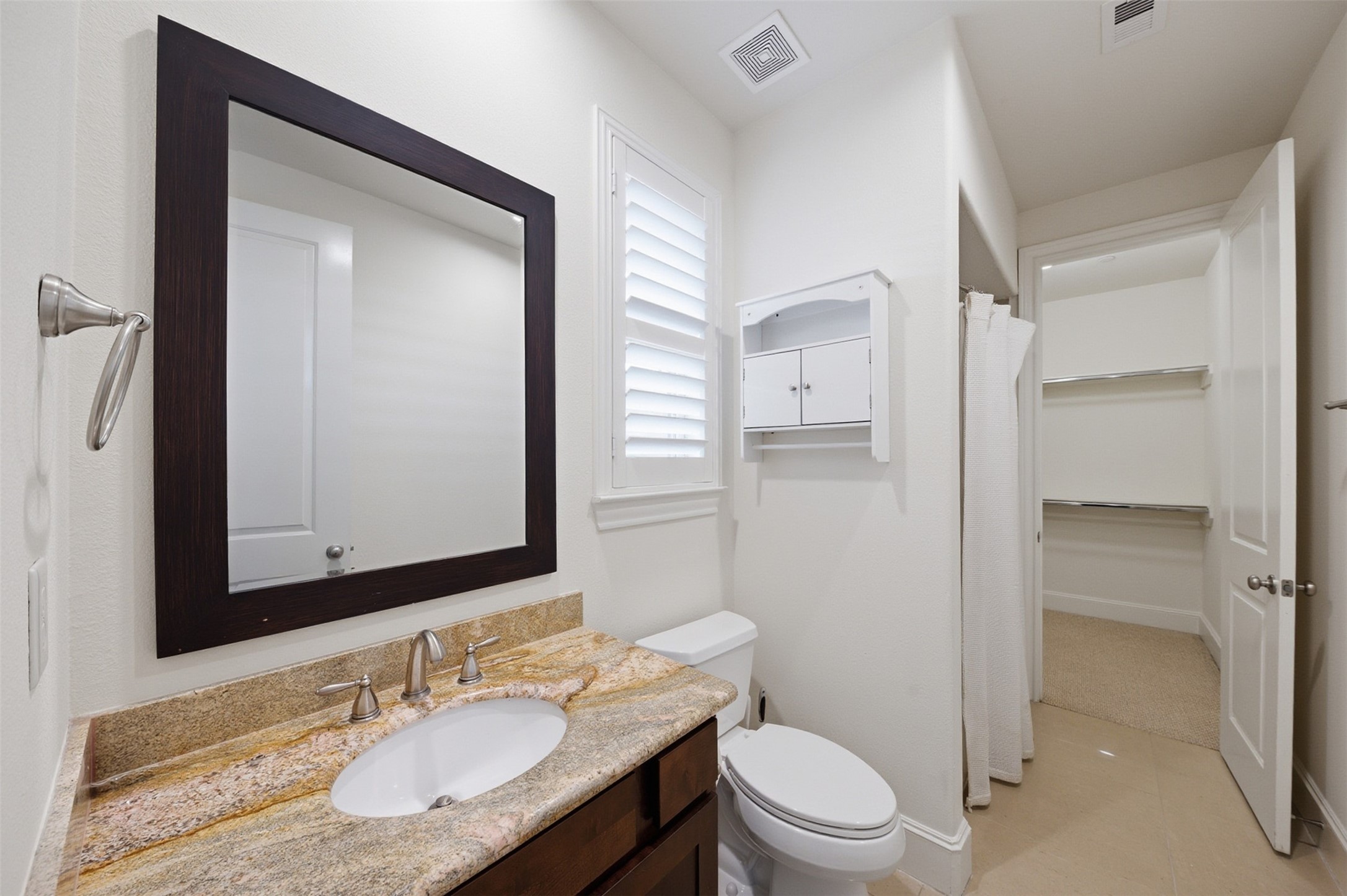 5606 Cohn Terrace Houston, TX 77007 - Photo 7 of 39 a bathroom with a granite countertop sink toilet a mirror and shower
