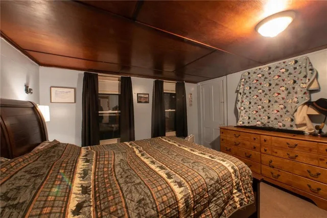 a bedroom with a large bed and a dresser
