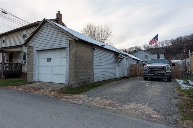 a view of a house with a backyard space and parking space