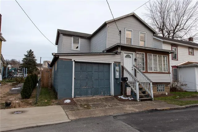 a front view of a house with a garage